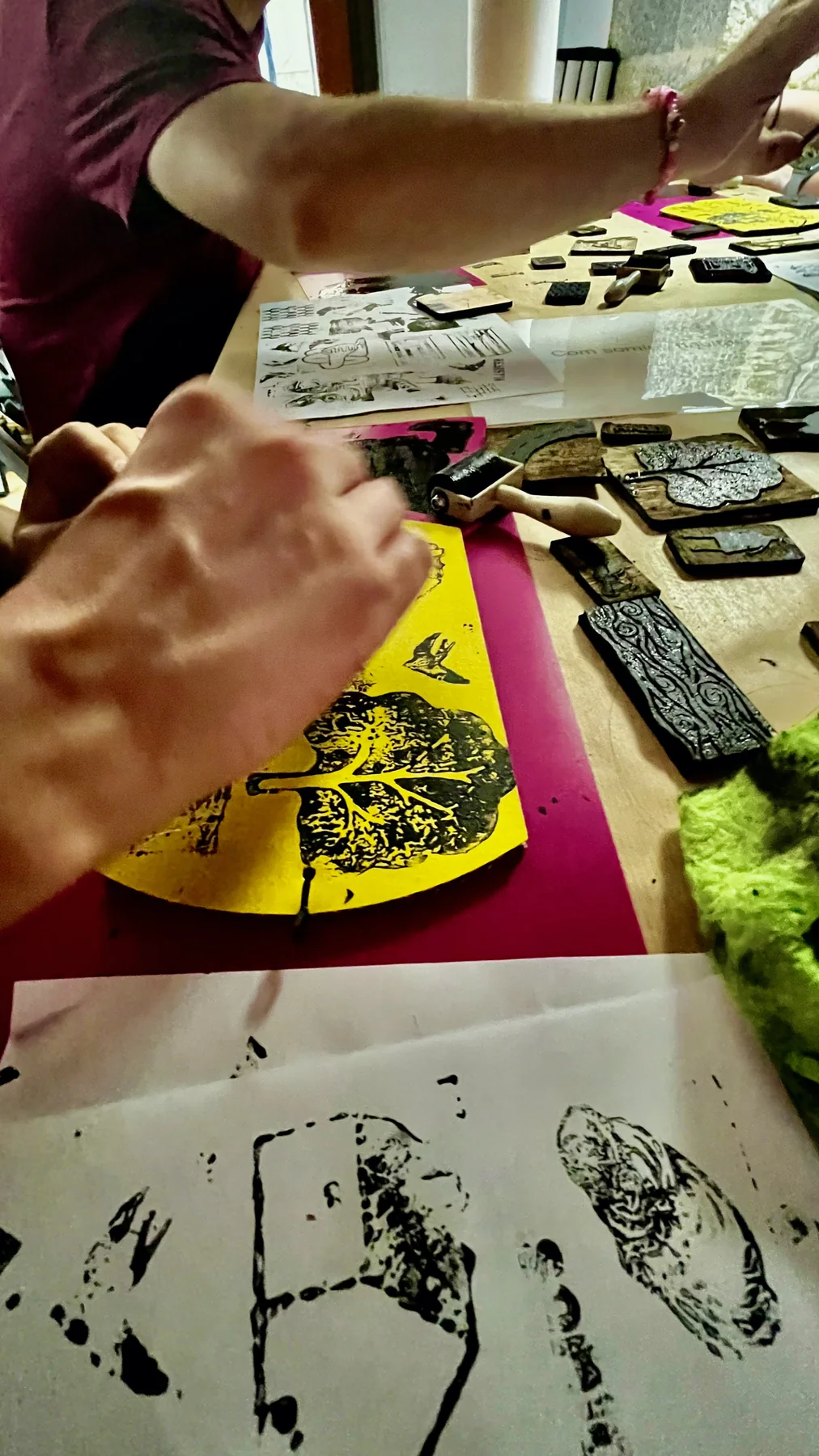 Manos estampando piezas durante un proceso de Refugi d’Imaginaris.